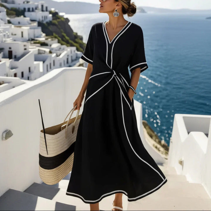 Women's maxi dress with V-neck and twisted front.